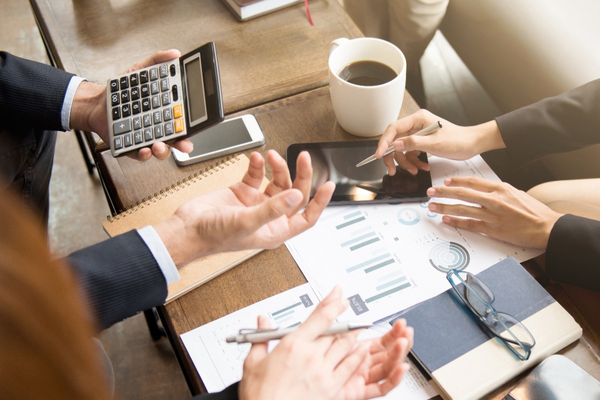 business-professionals-gathered-around-table-discussing-finances